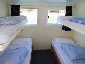 Backpacker dorm accommodation on a boat in the Abel Tasman National Park